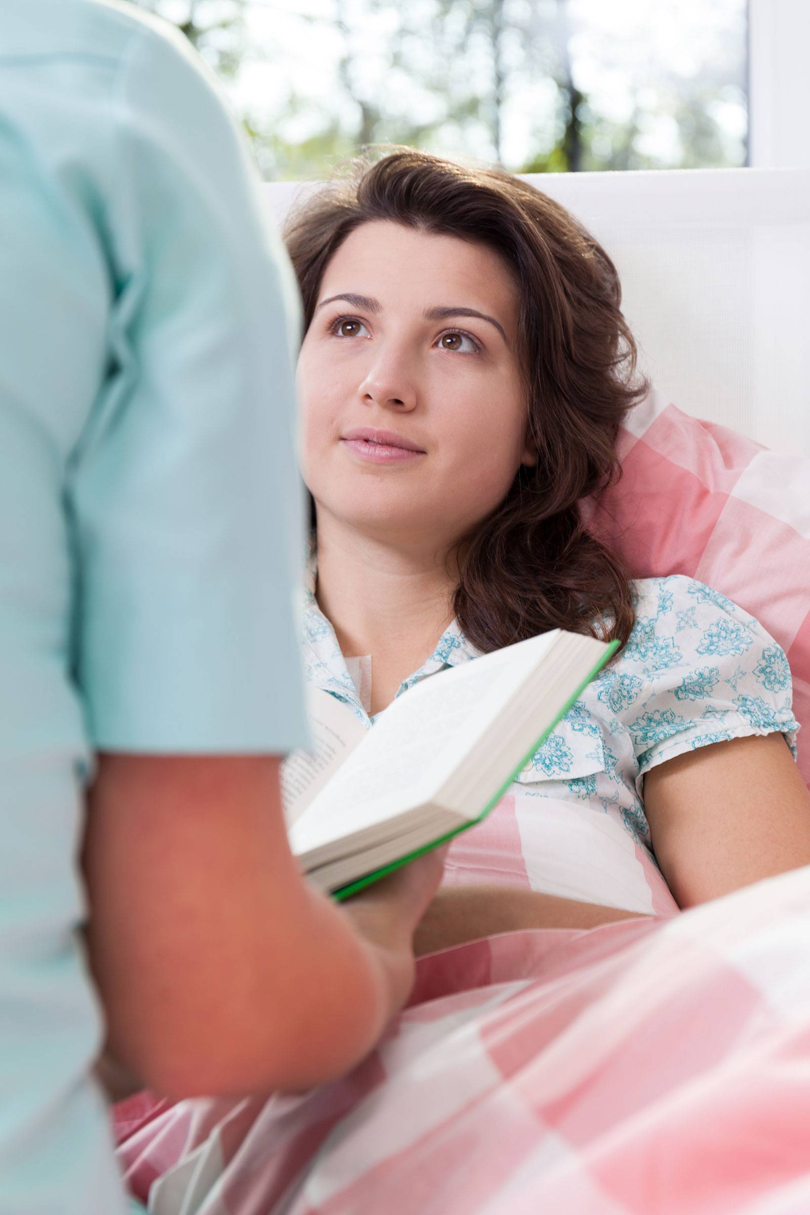 Healthcare provider reading to woman